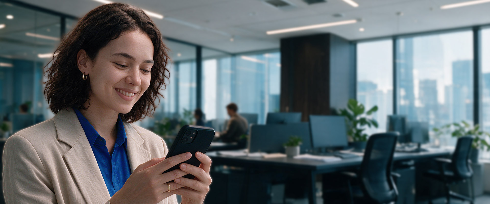 A woman holding a phone in an office